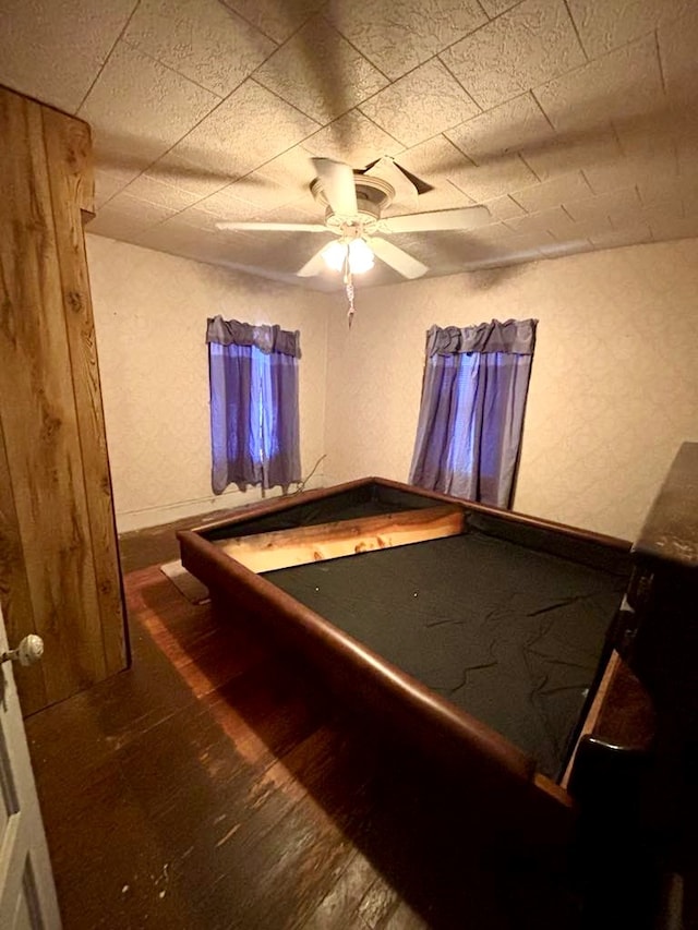 rec room featuring ceiling fan and dark hardwood / wood-style floors