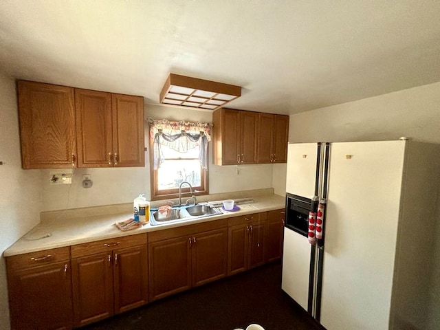 kitchen featuring white fridge with ice dispenser and sink