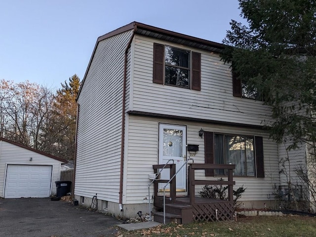 view of front of house with a garage and an outdoor structure