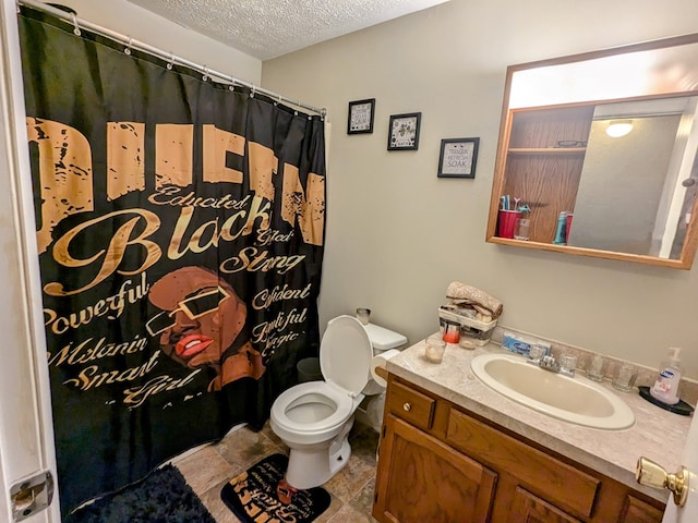 bathroom with toilet, vanity, walk in shower, and a textured ceiling