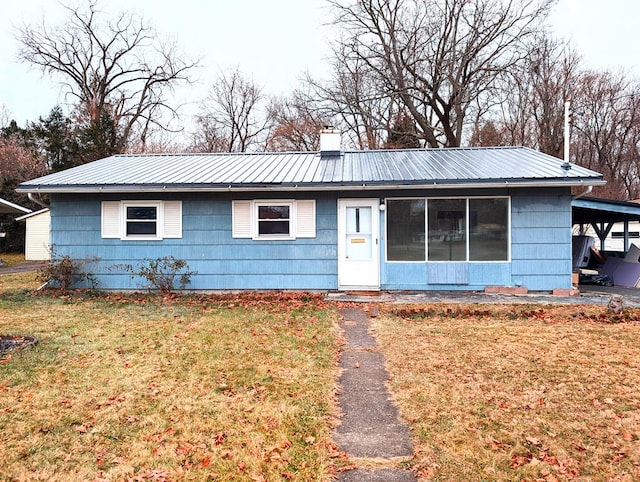 single story home featuring a front yard and a carport