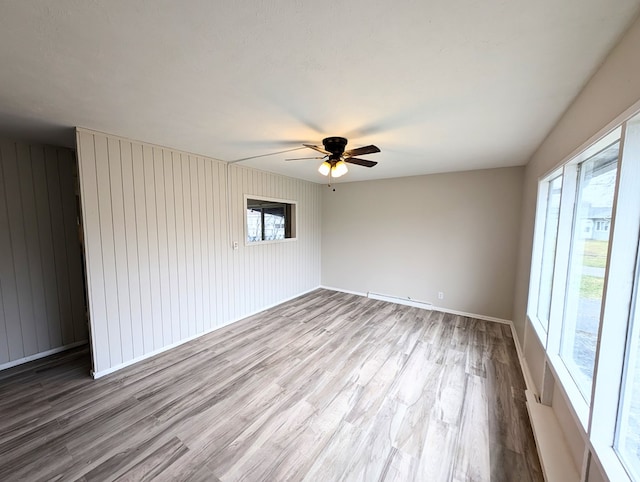 empty room with light hardwood / wood-style flooring and ceiling fan