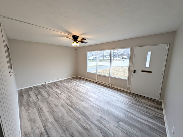 unfurnished room featuring ceiling fan and light hardwood / wood-style flooring