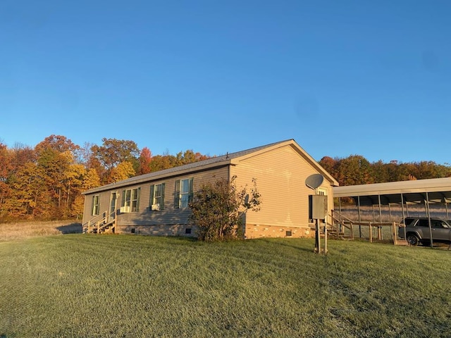 view of side of property featuring a lawn and a carport