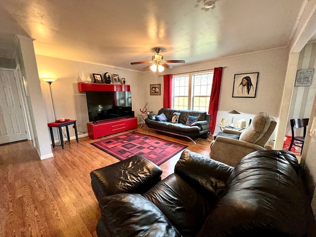 living room with wood-type flooring, ceiling fan, and crown molding