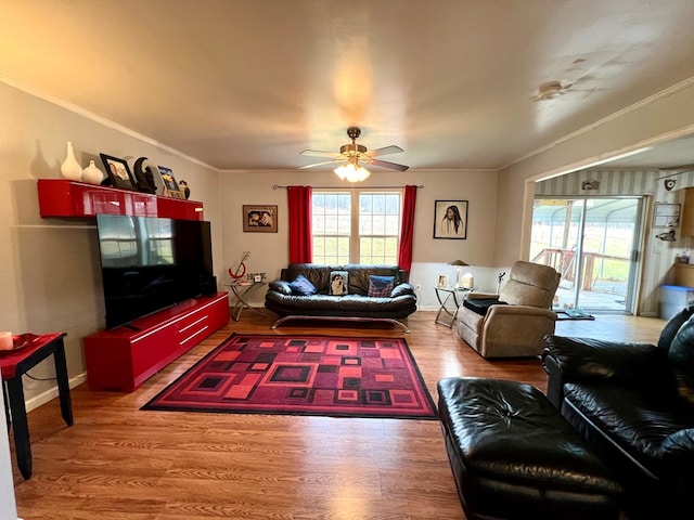 living room with ceiling fan, wood-type flooring, and ornamental molding