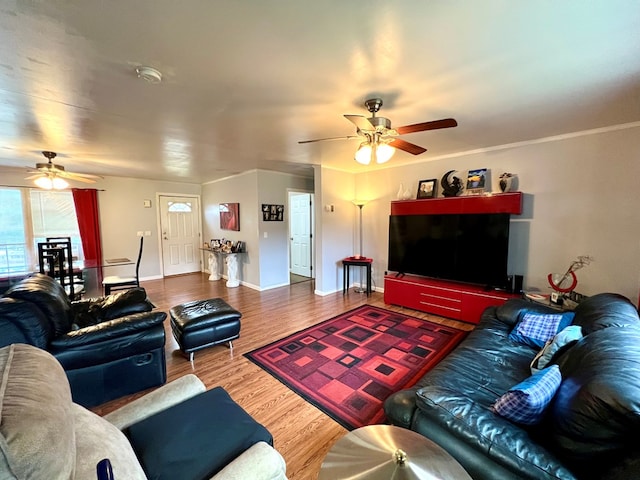 living room with wood-type flooring and ceiling fan