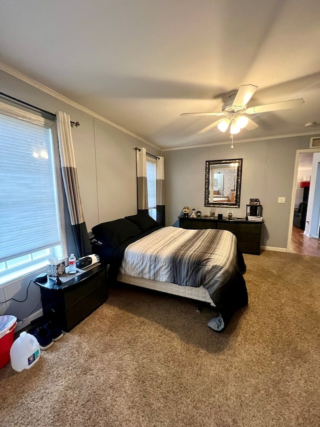 bedroom featuring ceiling fan, carpet floors, and ornamental molding