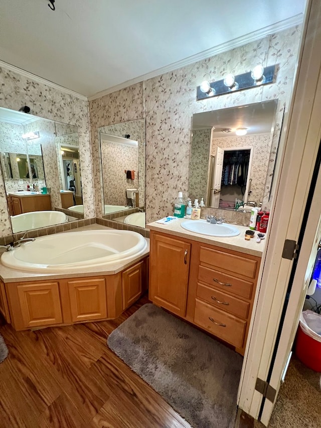 bathroom featuring crown molding, hardwood / wood-style floors, vanity, and plus walk in shower