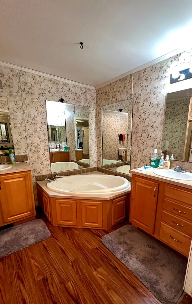 bathroom featuring crown molding, a washtub, vanity, and hardwood / wood-style flooring