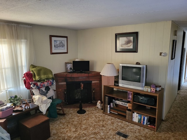 carpeted home office with wood walls and a textured ceiling