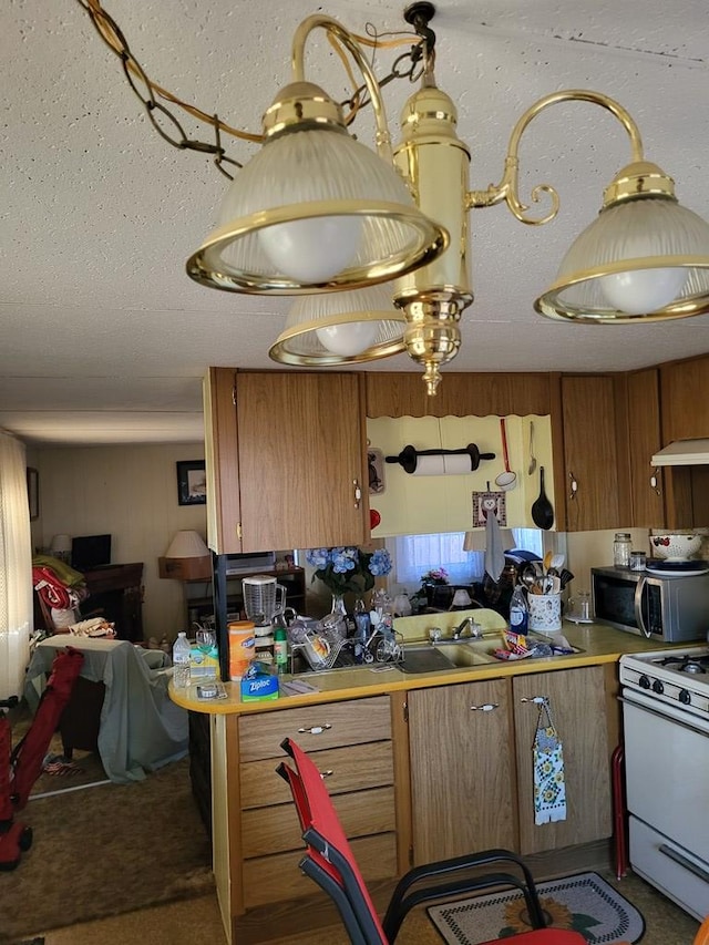 kitchen with white gas stove and a textured ceiling