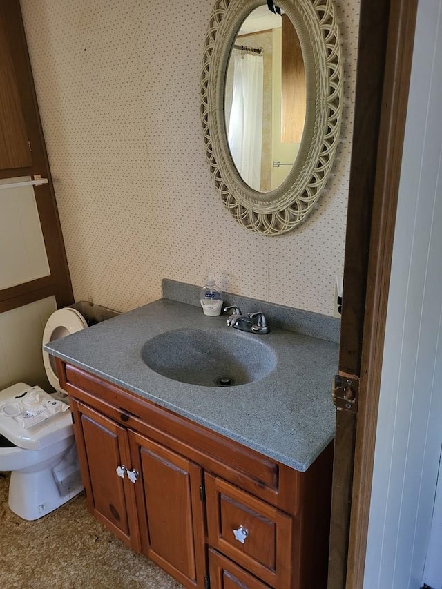 bathroom featuring vanity and toilet