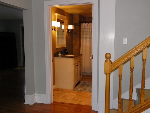 hallway with light wood-type flooring and sink