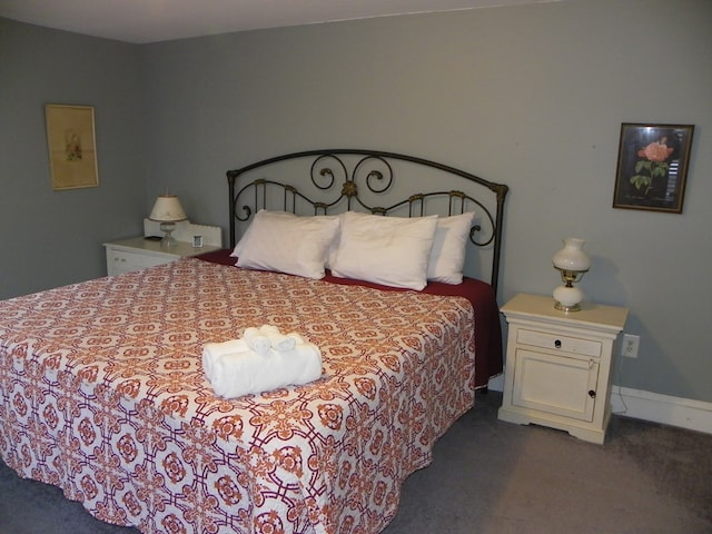 bedroom with dark colored carpet