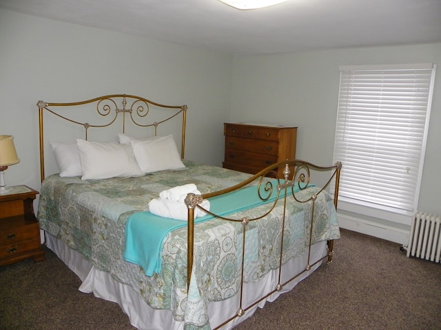 carpeted bedroom featuring radiator