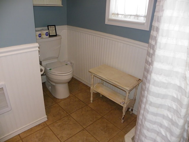 bathroom featuring tile patterned floors and toilet