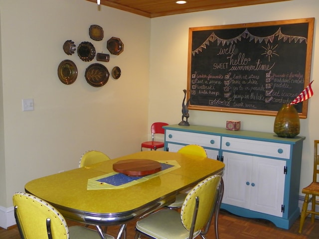 dining space featuring dark parquet flooring