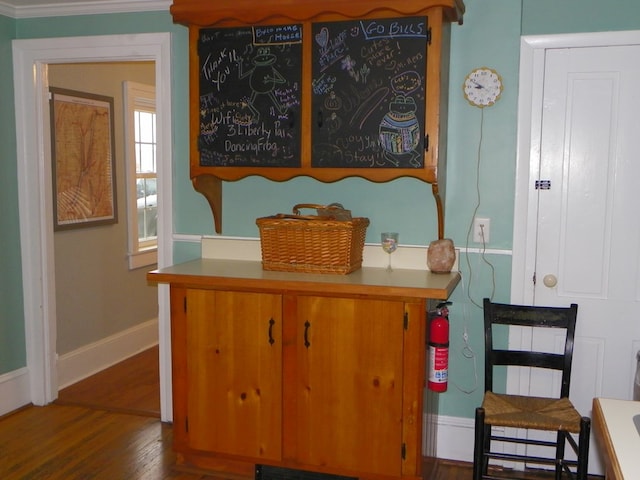 interior space featuring wood-type flooring and crown molding