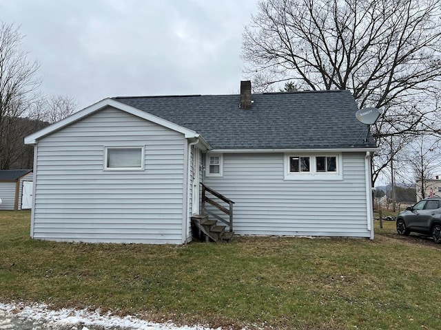 rear view of house with a yard