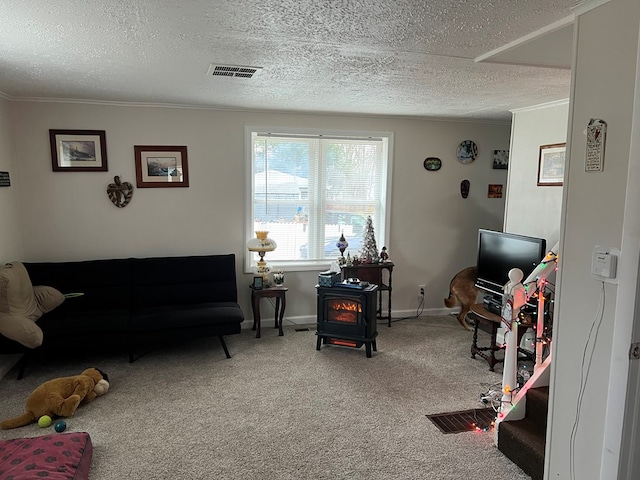 interior space featuring a textured ceiling, a wood stove, and ornamental molding