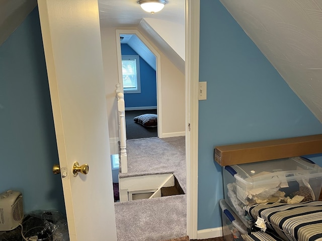 interior space with carpet floors and vaulted ceiling