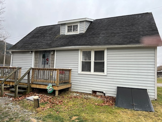 back of house with a lawn and a deck