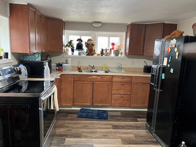 kitchen featuring black fridge with ice dispenser, a textured ceiling, stainless steel electric stove, dark wood-type flooring, and sink