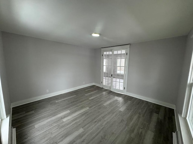 unfurnished room with french doors and dark hardwood / wood-style floors