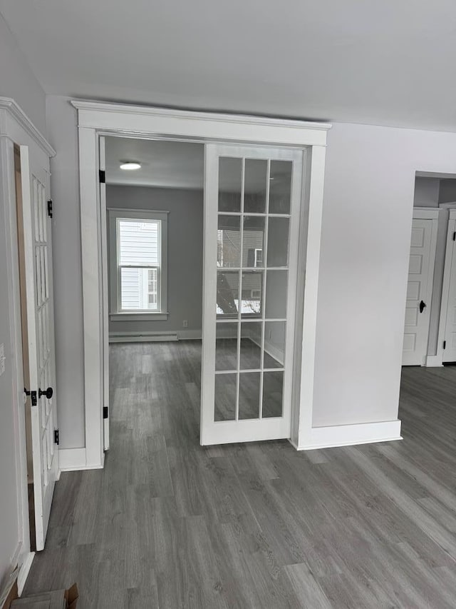 corridor with hardwood / wood-style flooring