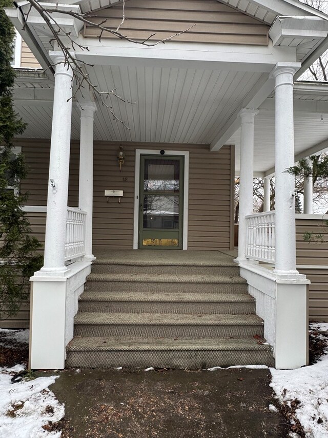 view of snow covered property entrance