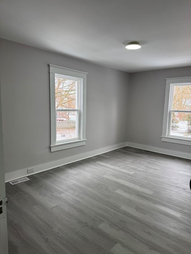 empty room with dark wood-type flooring