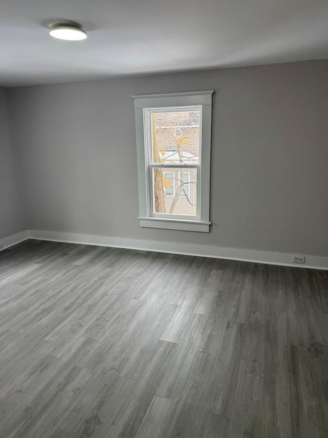 unfurnished room with dark hardwood / wood-style flooring