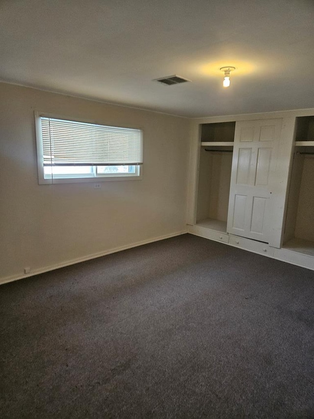 unfurnished bedroom with a closet and carpet