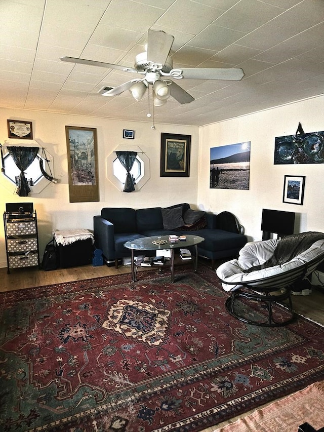 living room featuring hardwood / wood-style flooring and ceiling fan