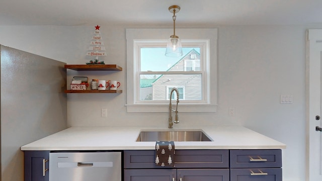 kitchen featuring dishwasher, sink, and hanging light fixtures