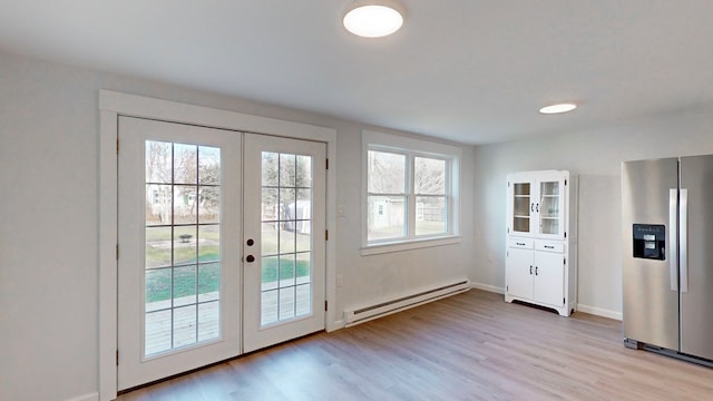 entryway featuring french doors, a baseboard radiator, and light hardwood / wood-style floors