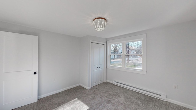 unfurnished bedroom featuring light carpet, a closet, and baseboard heating