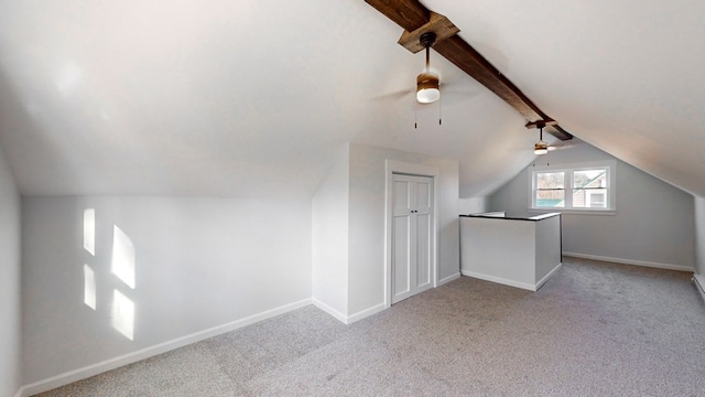 bonus room featuring lofted ceiling with beams, ceiling fan, and light carpet