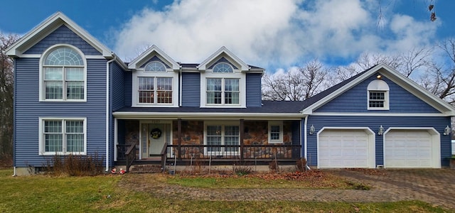 view of front of home with covered porch and a garage