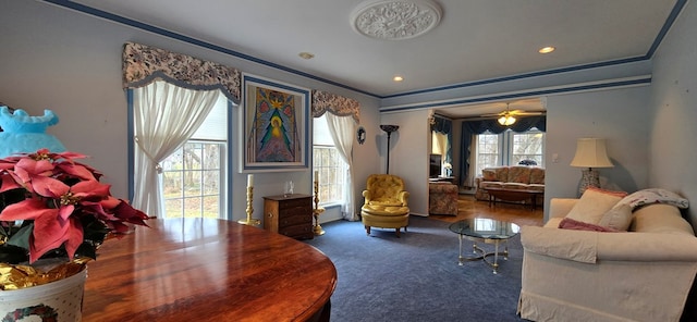 living room with wood-type flooring, ceiling fan, and crown molding