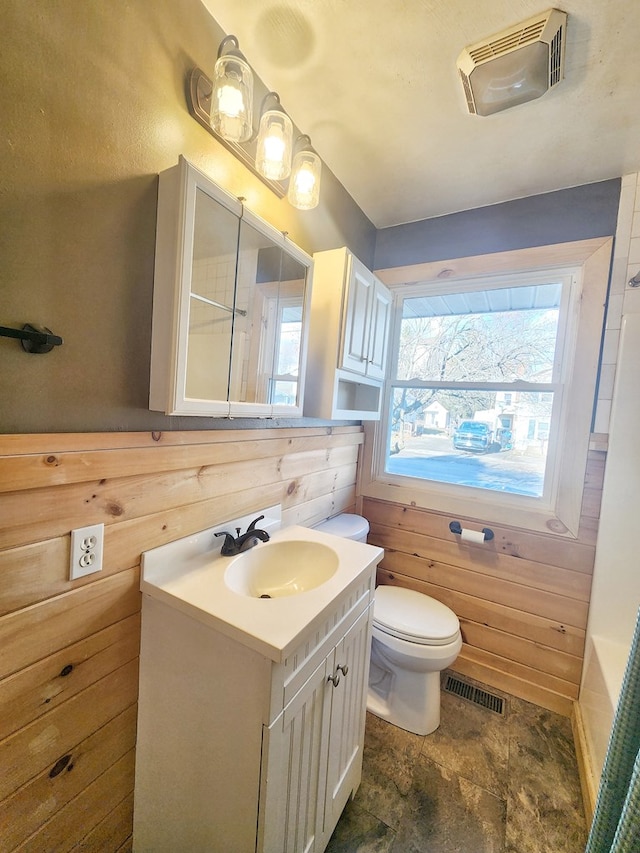 full bathroom featuring independent shower and bath, vanity, toilet, and wooden walls