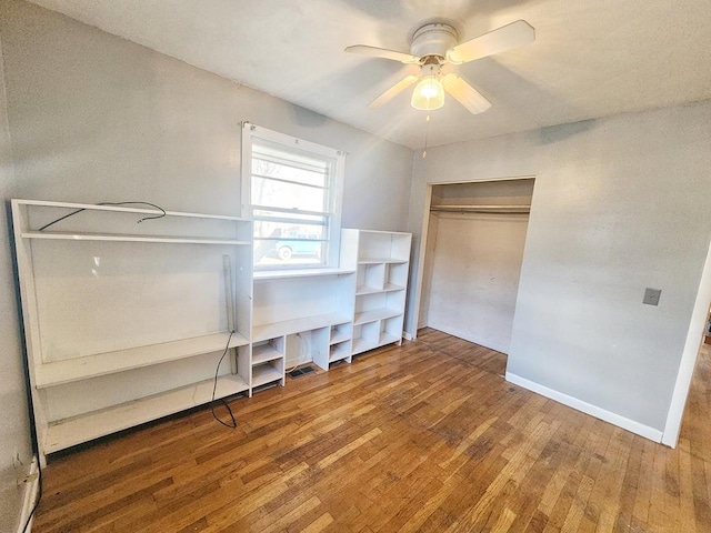 unfurnished bedroom with hardwood / wood-style floors, a closet, and ceiling fan