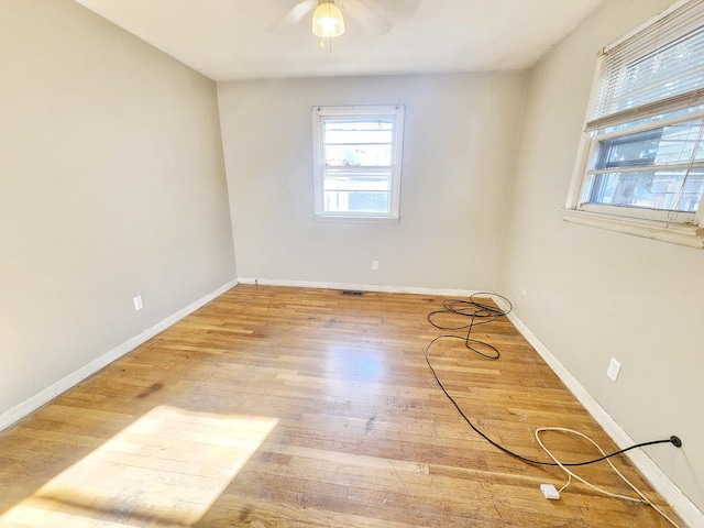 empty room featuring light wood-type flooring and ceiling fan