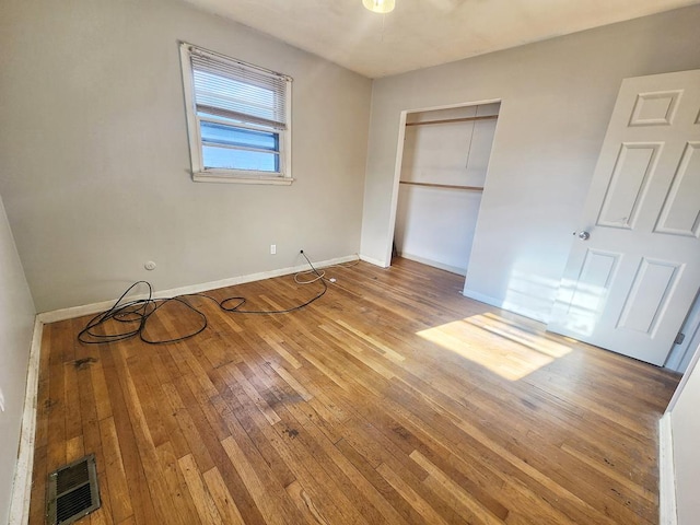 unfurnished bedroom featuring hardwood / wood-style flooring