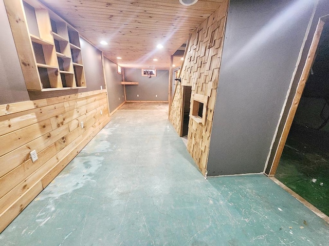 hallway with wood walls and wooden ceiling