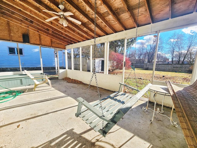 unfurnished sunroom featuring ceiling fan and vaulted ceiling