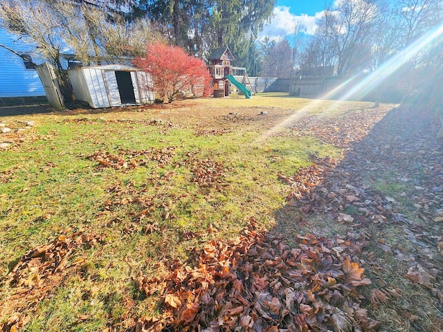 view of yard featuring a shed and a playground