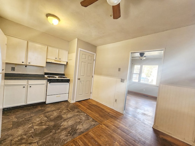 kitchen with white range oven, white cabinetry, and dark wood-type flooring