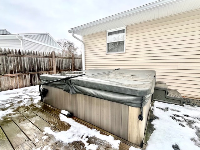 snow covered deck featuring a hot tub